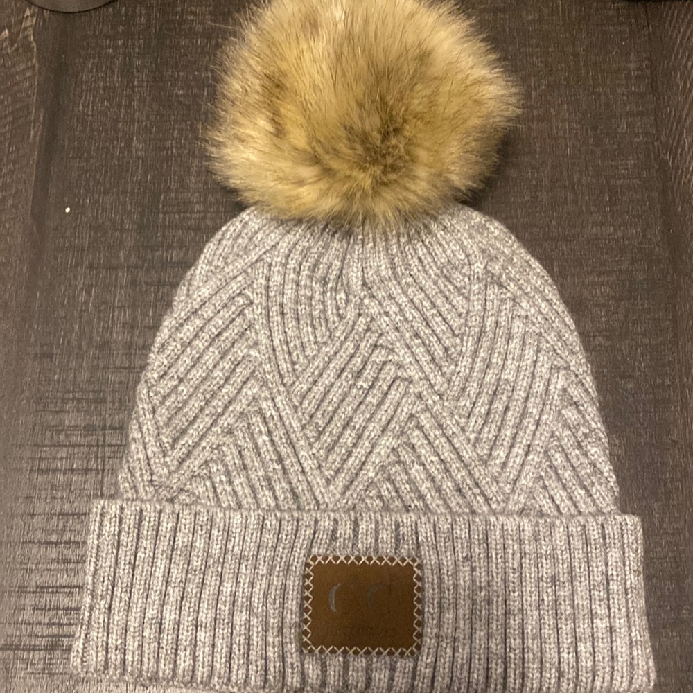 Gray CC beanie with pom. one size fits all. never worn.
